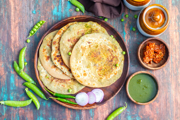 Matar paratha is a delicious Indian flatbread stuffed with spiced mashed green peas, cooked until golden and served with chutney.