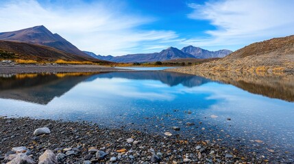Serene landscape with mountains reflecting in calm water.