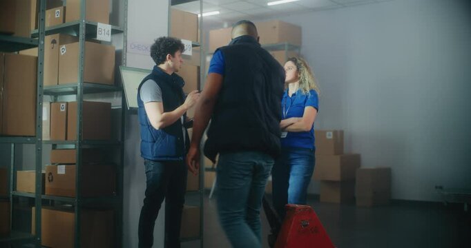 Inventory specialist gives instructions to colleagues, uses tablet computer. Diverse warehouse employees working in sorting center with cardboard boxes, E-commerce online orders, goods for shipping.