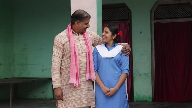 Happy rural indian father with daughter wearing school uniform standing together at home. Love and bonding. Fatherhood, Education. India 4k