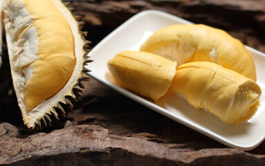 Durian in a white plate on a wooden background