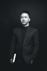 a black and white photo of a man in a suit and tie