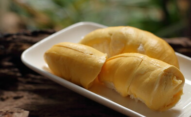 Durian in a white plate on a wooden background