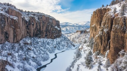 Winter canyon view; snowy cliffs border river; mountains; nature background