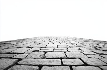 Monochrome cobblestone road vanishing point.