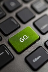 A closeup of a laptop keyboard with a green button rectangle with text "GO." on it