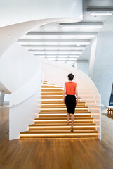 Woman walking on the spiral staircase