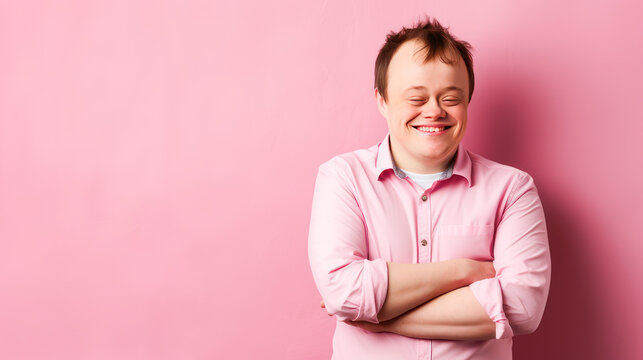 Portrait of smiling laughing man with Down syndrome pink background.