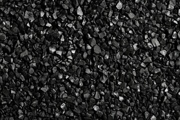 Black background with small particles of sand or dust for a design template, print, and texture