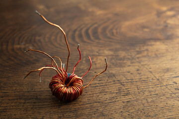 electrical and magnetic forces of a coil on a rustic retro wooden table.