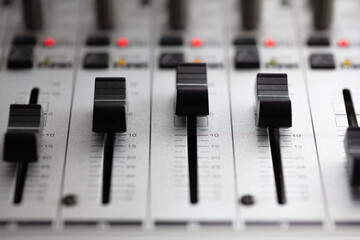 Knobs and switches of audio mixer or recording console. Recording background.  shallow depth of...