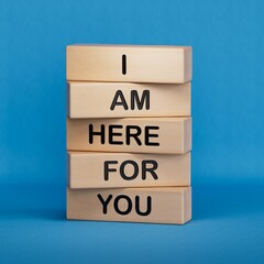 I am here for you symbol. Concept words I am here for you on wooden blocks.Business and I am here for you concept. Copy space.3D rendering on blue background.
