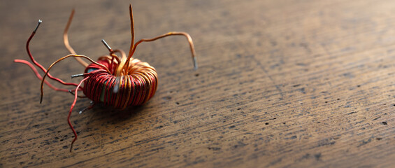 electrical and magnetic forces of a coil on a rustic retro wooden table.