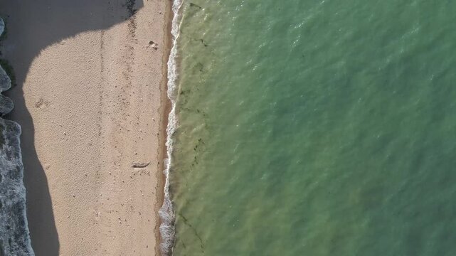Botany Bay coastline. High aerial drone footage, bird's eye view of the sea and beach. Slowly moving forwards. 1 of 14