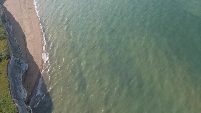 Botany Bay coastline. High aerial drone footage of the sea and beach. Slowly moving forwards and panning upwards to show expansive coastline and sea. 3 of 14