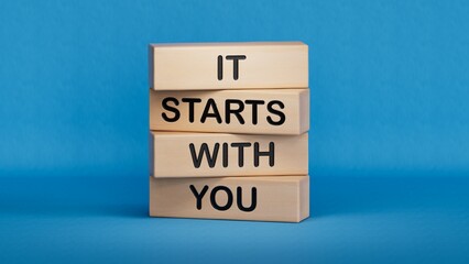 It starts with you symbol. Wooden blocks with words It starts with you.Business and It starts with you concept. Copy space.3D rendering on blue background.