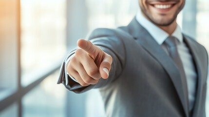 Confident man in suit pointing forward.