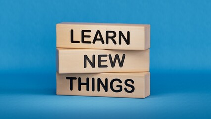 Learn new things symbol. Concept words Learn new things on wooden blocks. Business and Learn new things concept. Copy space.3D rendering on blue background.