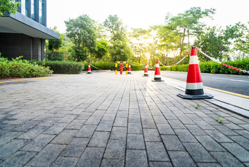 Cone barricade between pedestrian walkway and highway