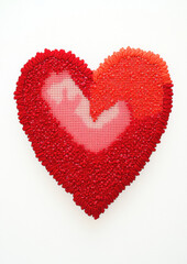 Heart shaped cross stitch in vibrant red tones with intricate details