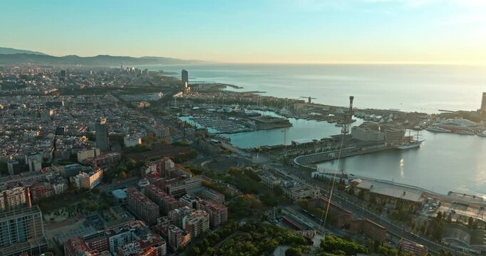 Scenic Aerial Sunrise Over Barcelona Coastline Mediterranean Embankment and Harbor in Urban Beauty. High quality 4k footage