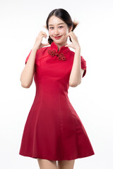 Portrait of joyful beauty Asian woman in red Cheongsam Chinese traditional dress celebrating and making heart shape hand sign isolated on white background.