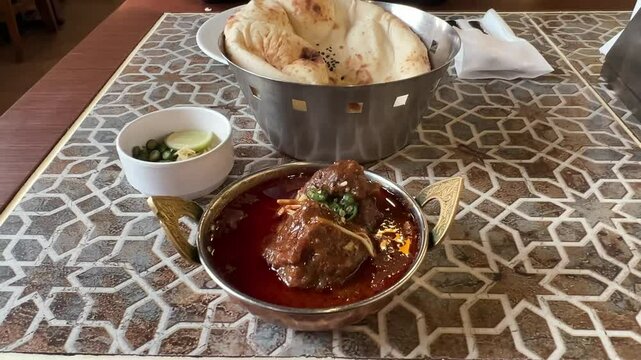 Close up shot of Mutton Nihari served with Khameri Roti during winter,