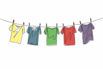 Single one line drawing 5 colorful t-shirts are drying on the clothesline. Adding brightness to the morning when drying. Laundry. National Hanging Out Day. Continuous line design graphic illustration