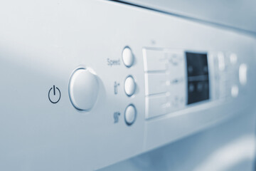 Close-up view of dishwasher start button and control panel