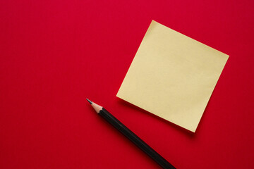 Top view of yellow sticky note paper on blue background