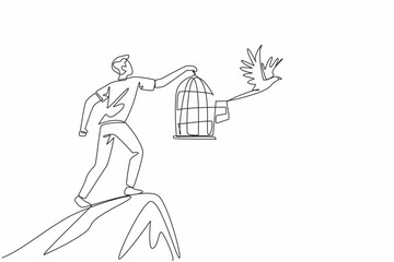 Continuous one line drawing man in casual clothes stood on hill releasing birds. Struggle to high ground to release into the wild. National Go Birding Day. Single line draw design vector illustration