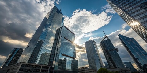 Fototapeta premium Modern Architectural Skyline A Cluster of Glass and Steel Towers Reaching for the Sky Under a Dramatic Cloudscape
