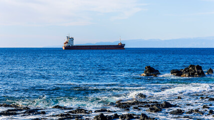 Oil tanker underway towards open sea. Crude oil tanker ship, a merchant ship specially designed for chemical products transportation