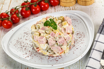 Russian traditional Olivier salad with sausages