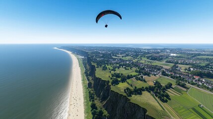 A scenic view of a coastline with a paraglider above.