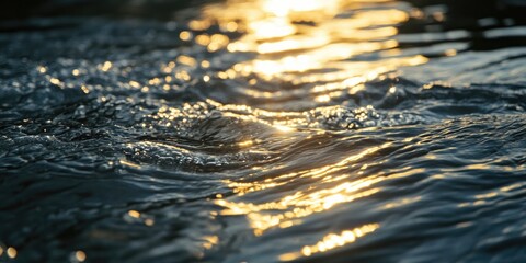 Glistening golden light reflecting on rippling dark water surface with soft waves creating a tranquil and serene backdrop in nature