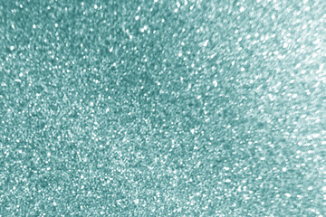 Green glitter light shining background. Starry night sky. Galaxy space. Glowing stars in the night. New Year, Christmas and Celebration concept.