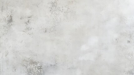 A white wall with a few spots and a few cracks