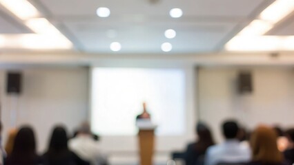 Innovation Summit Blur: A blurred conference stage with a speaker presenting to a dimly lit, attentive audience.
