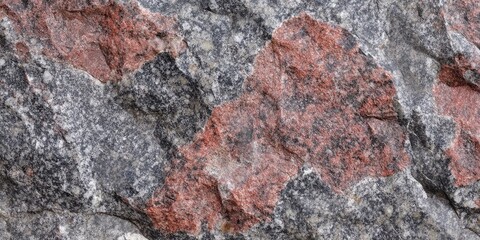 Gray and red granite stone texture featuring large patches of dark gray and rust red tones ideal for construction material background usage