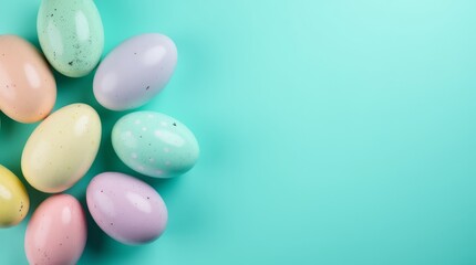 Pastel colored Easter eggs arranged on turquoise background with copy space. Minimal holiday decoration concept