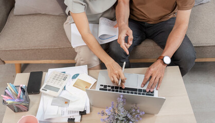 Elderly Couple Managing Finances Together at Home with Laptop and Calculator for Budget Planning and Expense Tracking
