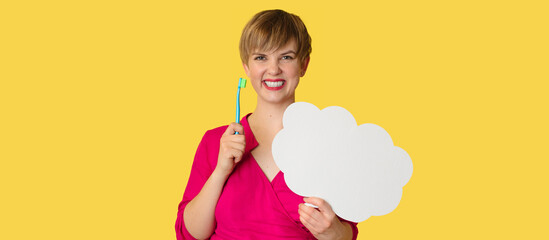 A young woman with a snow-white smile holds a toothbrush and a blank sheet in the form of a cloud for writing text on it. Panoramic banner