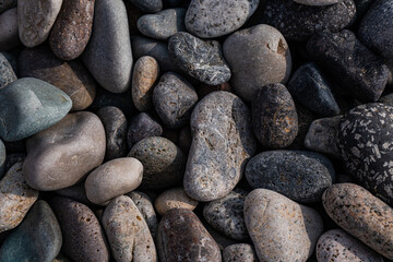 Wet pebbles on the sea shore