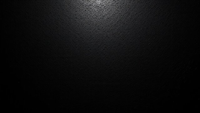 A spotlight illuminates a textured black wall from above, creating dramatic shadows and depth in an intimate, worm's eye view