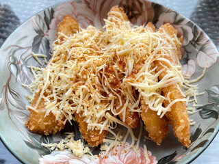 Banana fritters with cheese on a plate in a restaurant.
