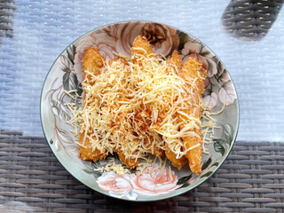 Banana fritters with cheese on a plate in a restaurant.
