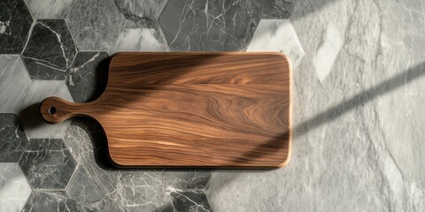 Wooden cutting board on a contemporary hexagonal marble countertop top view with dark and light marble tones shadow play and natural wood grain details