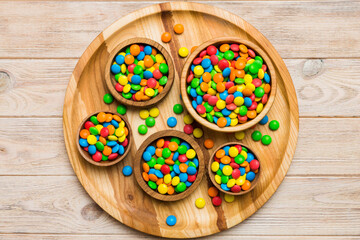 different colored round candy in bowl and jars. Top view of large variety sweets and candies with copy space