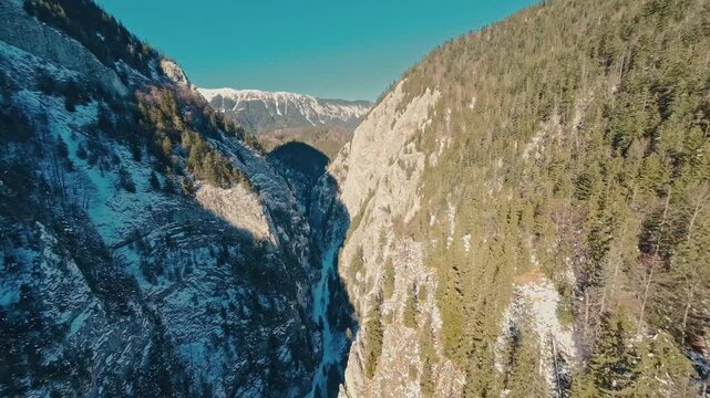 FPV drone flight into Zarnesti Gorges, capturing stunning winter landscapes, forested cliffs, and serene Carpathian beauty